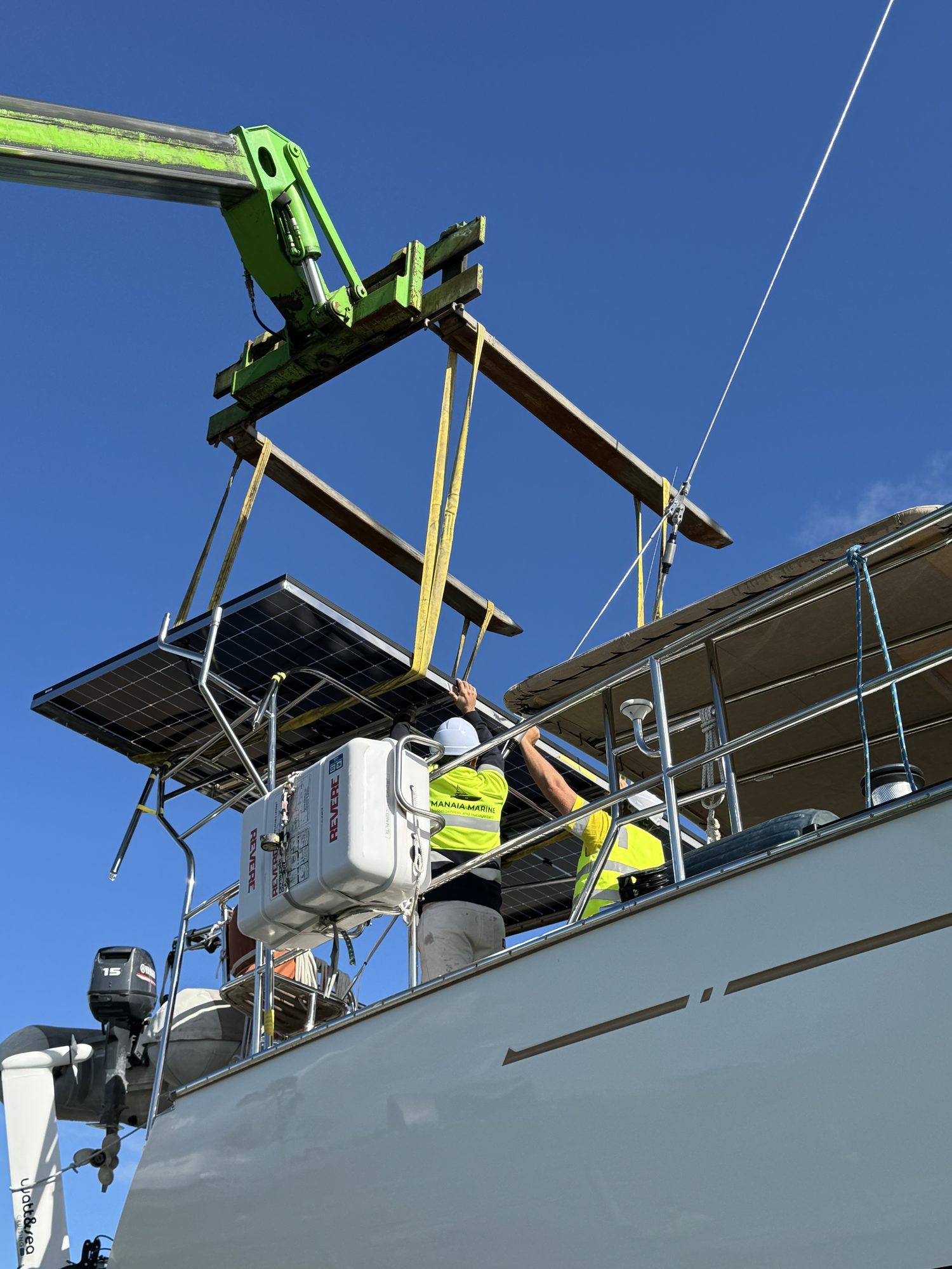 Crew installing a solar panel via boom lift